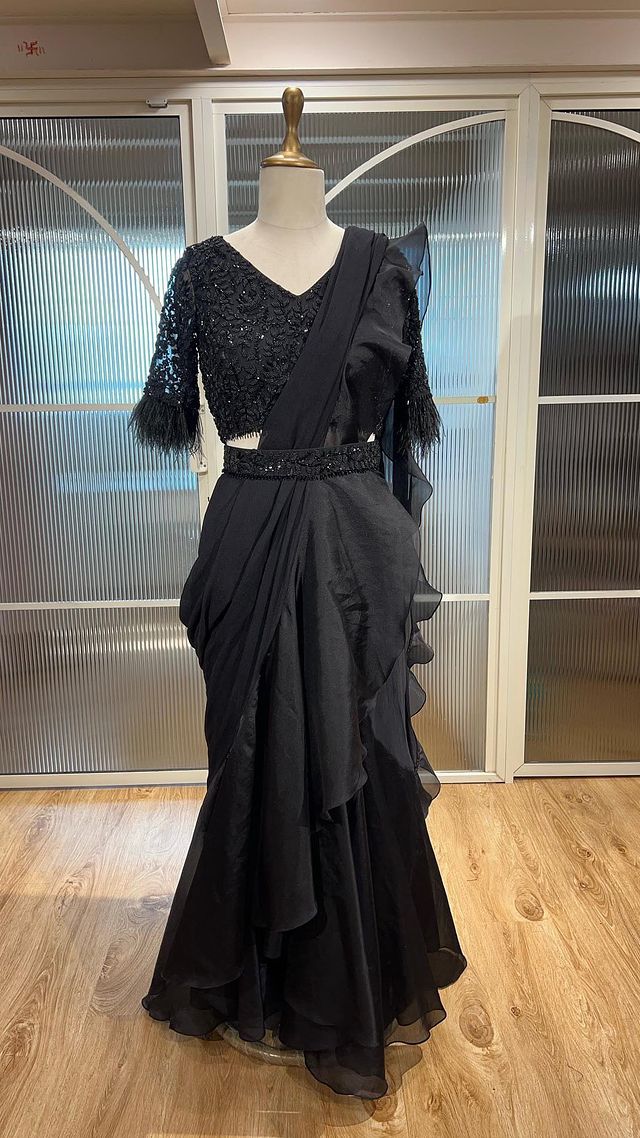 Love for Black 🖤 This Predraped ruffle saree with intricate hand embroidery work is a must have. 
O