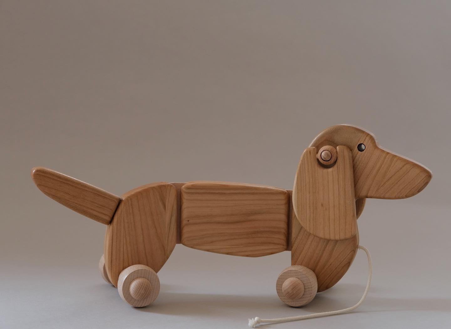 Think this large wooden dachshund pull-toy is adorable!? He is a keeper. Click on over to our websit