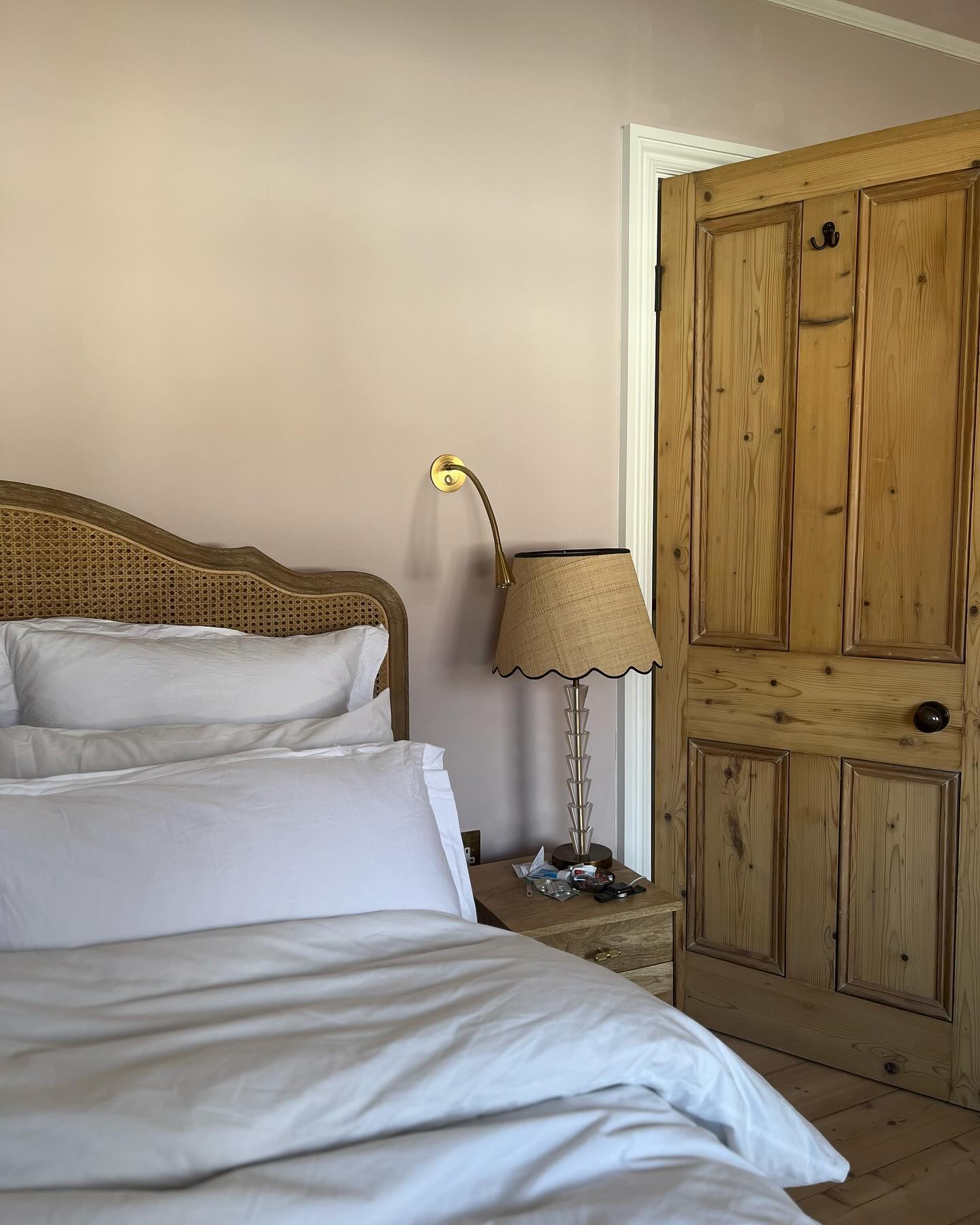 Our master bedroom, complete with rattan wardrobes, bold striped blinds and an original Victorian Fi