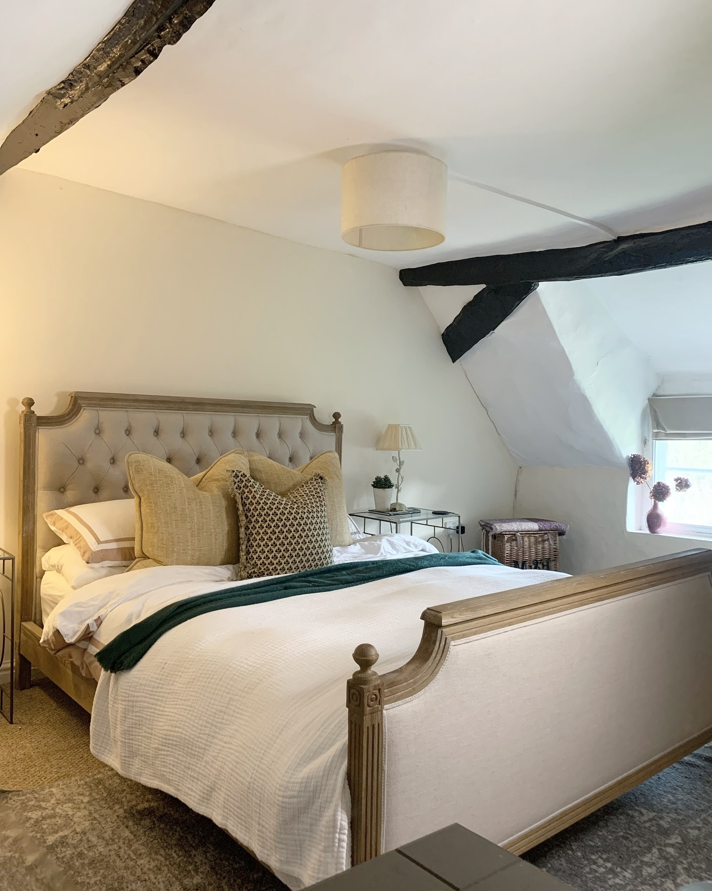 Thereâ€™s something about sloped ceilings and original beams. 

A cosy cottage bedroom where the ori