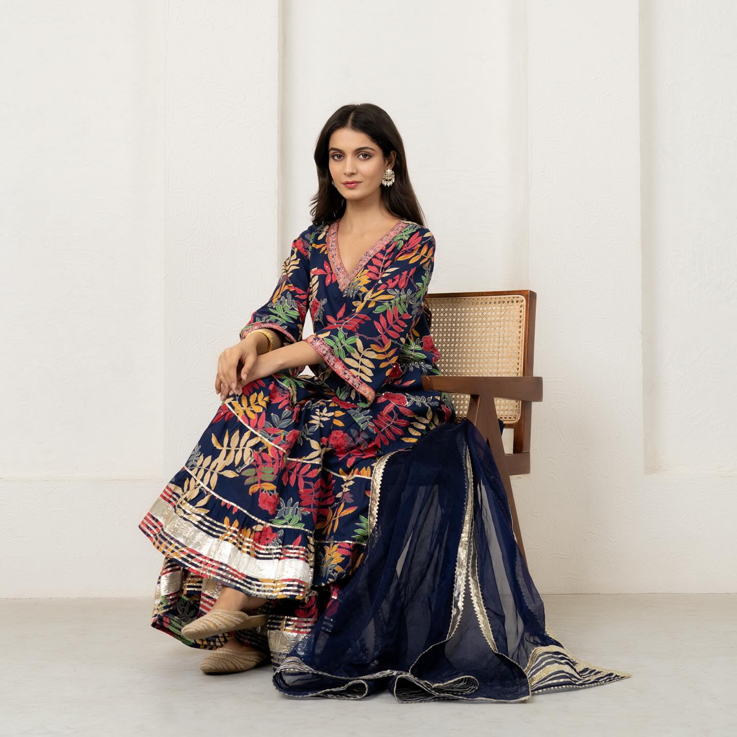 Embrace the allure of nature's palette in this navy blue printed sharara set adorned with whimsical 
