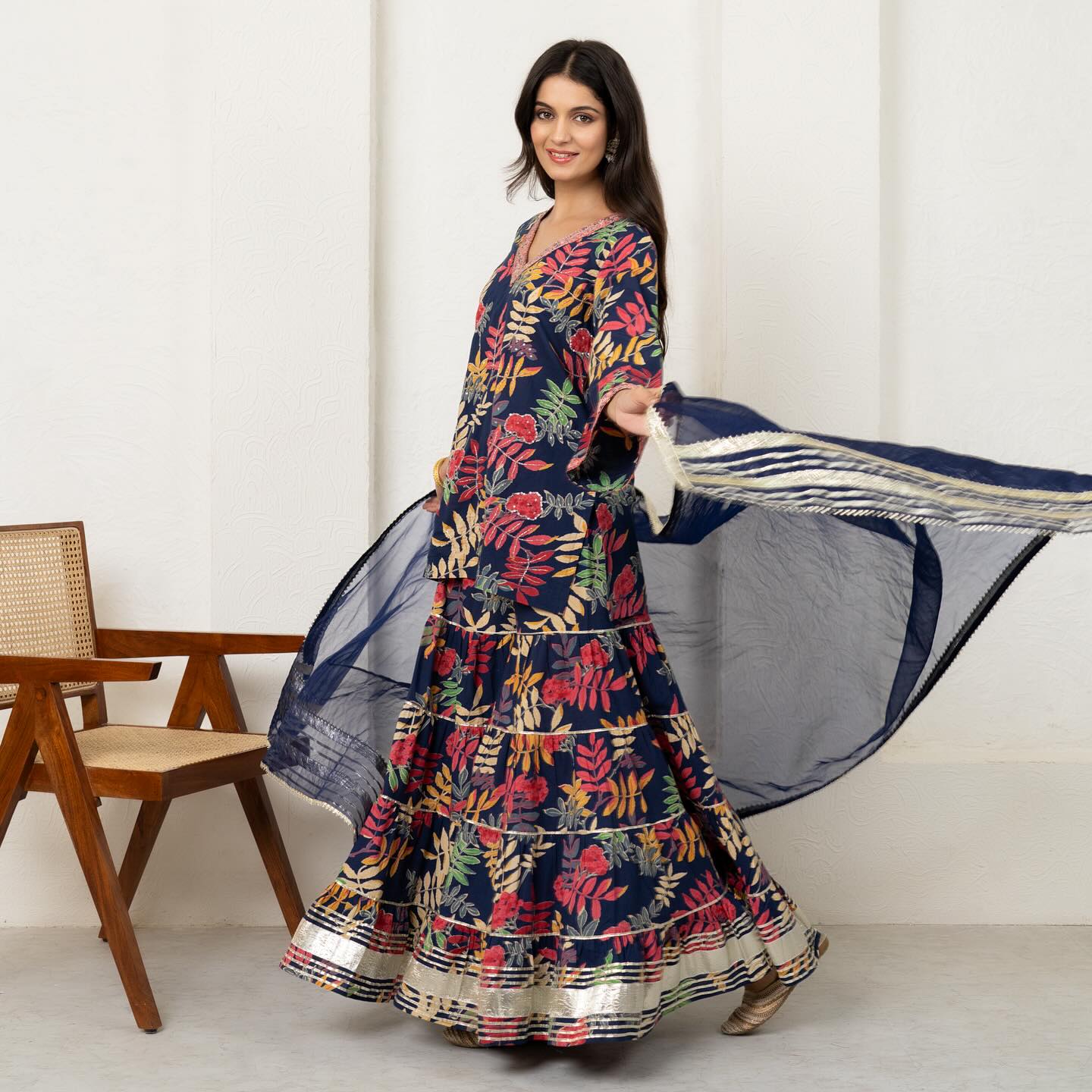 Embrace the allure of nature's palette in this navy blue printed sharara set adorned with whimsical 